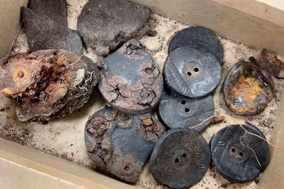 In addition to human remains, the boxes discovered at FAU contained several leather shoe heels and plastic coat buttons.