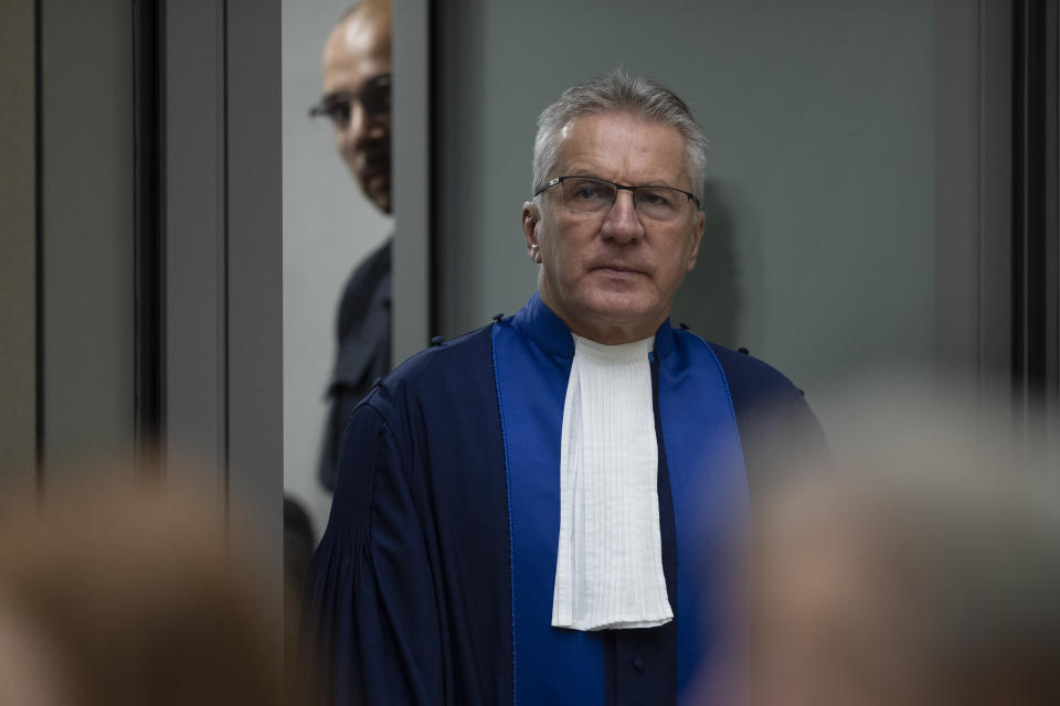 Presiding ICC judge Robert Fremr enters the courtroom to read the sentence for Congolese militia commander Bosco Ntaganda at the International Criminal Court in The Hague, Netherlands, Thursday, Nov. 7, 2019. The ICC delivered the sentence on Ntaganda, accused of overseeing the slaughter of civilians by his soldiers in the Democratic Republic of Congo in 2002 and 2003. (AP Photo/Peter Dejong, Pool)