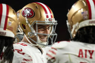 San Francisco 49ers quarterback Jimmy Garoppolo smiles in the huddle during the first half of an NFL football game against the Denver Broncos in Denver, Sunday, Sept. 25, 2022. (AP Photo/Jack Dempsey)