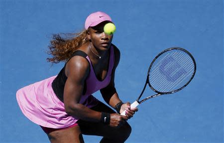 Serena Williams of the U.S. eyes the ball during her women's singles match against Daniela Hantuchova of Slovakia at the Australian Open 2014 tennis tournament in Melbourne January 17, 2014. REUTERS/Jason Reed