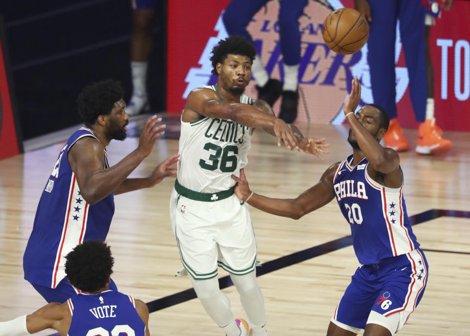 Boston Celtics guard Marcus Smart (36) passes the ball past Philadelphia 76ers guard Alec Burks (20) during the second quarter of Game 4 of an NBA basketball first-round playoff series, Sunday, Aug. 23, 2020, in Lake Buena Vista, Fla. (Kim Klement/Pool Photo via AP)