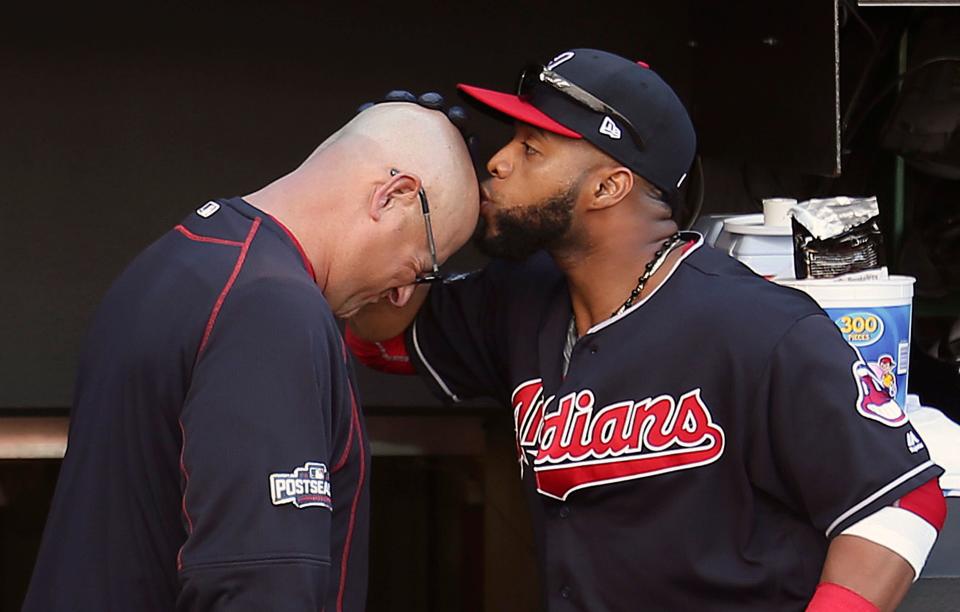 Cleveland's Carlos Santana, right, kisses manager Terry Francona's head before Game 2 of the American League Division Series against the Boston Red Sox on Friday, Oct. 7, 2016, in Cleveland.