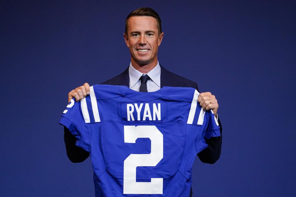 Indianapolis Colts quarterback Matt Ryan holds his new jersey following a press conference at the NFL team's practice facility in Indianapolis, Tuesday, March 22, 2022. (AP Photo/Michael Conroy)