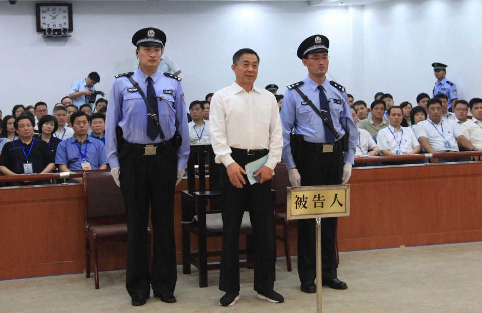 Ousted Chinese politician Bo Xilai (C) listens to his verdict inside the court in Jinan, Shandong province September 22, 2013, in this photo released by Jinan Intermediate People's Court. The court sentenced former Chongqing Municipality Communist Party Secretary Bo to life in prison on Sunday after finding him guilty of all the charges he faced of corruption, taking bribes and abuse of power. REUTERS/Jinan Intermediate People's Court/Handout via Reuters (CHINA - Tags: POLITICS CRIME LAW TPX IMAGES OF THE DAY) ATTENTION EDITORS - THIS IMAGE HAS BEEN SUPPLIED BY A THIRD PARTY. FOR EDITORIAL USE ONLY. NOT FOR SALE FOR MARKETING OR ADVERTISING CAMPAIGNS. THIS PICTURE WAS PROCESSED BY REUTERS TO ENHANCE QUALITY. AN UNPROCESSED VERSION WILL BE PROVIDED SEPARATELY. NO SALES. NO ARCHIVES