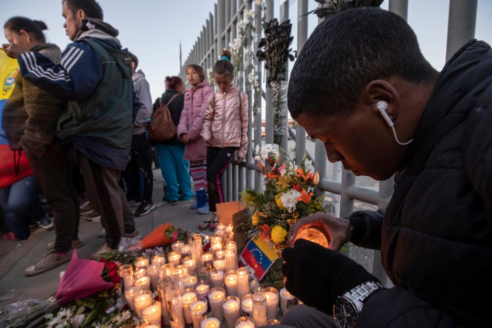 Migrants hold a vigil this week at the gate of the Mexican facility in Juárez where 39 migrants died in a fire at the center as they were being detained Monday night.