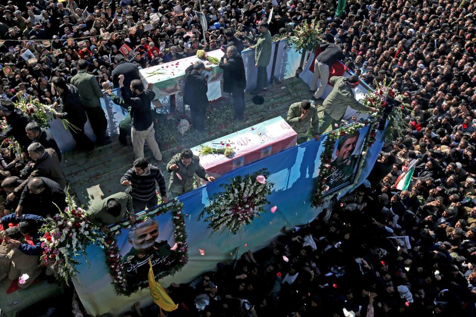 Iranian mourners gather around a vehicle carrying the coffin of slain top general Qasem Soleimani during the final stage of funeral processions, in his hometown Kerman on January 7, 2020. - Soleimani was killed outside Baghdad airport Friday in a drone strike ordered by US President Donald Trump, ratcheting up tensions with arch-enemy Iran which has vowed "severe revenge". The assassination of the 62-year-old heightened international concern about a new war in the volatile, oil-rich Middle East and rattled financial markets. (Photo by ATTA KENARE / AFP) (Photo by ATTA KENARE/AFP via Getty Images)