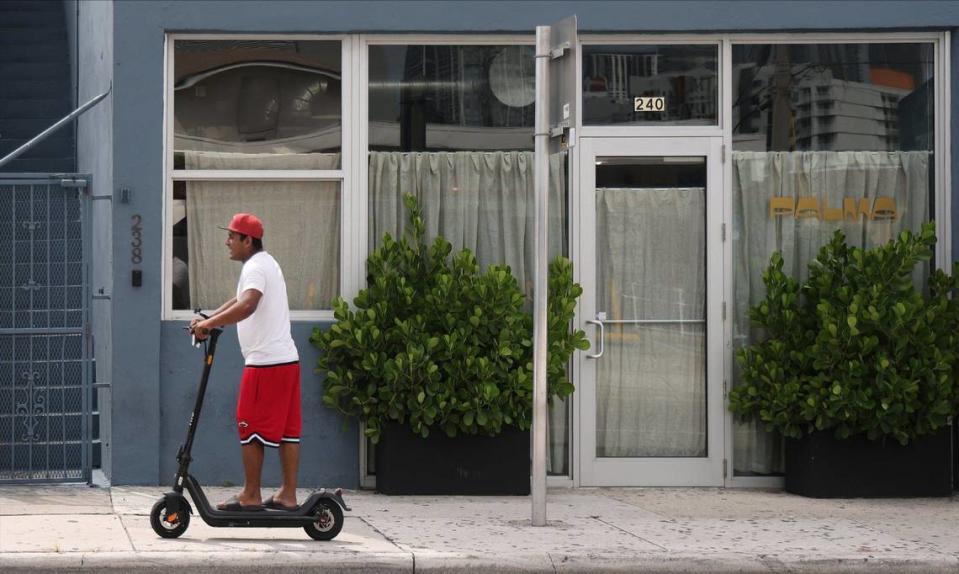 A neighbor rides past the small but mighty Palma restaurant, which opened earlier this year.