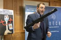 James Swartz, director of World Against Toys Causing Harm, holds a realistic toy machine gun during a news conference unveiling the organization's list of worst toys for the holidays, Tuesday, Nov. 19, 2019, in Boston. (AP Photo/Michael Dwyer)