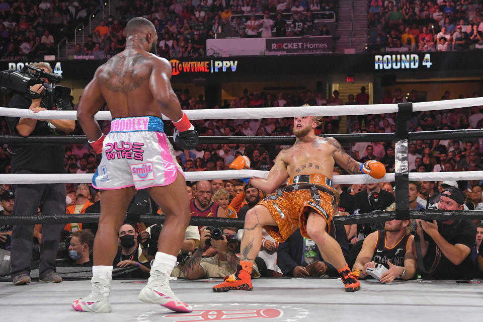 Jake Paul (pictured right) holds onto the ropes after being punched by Tyron Woodley (pictured left) in their cruiserweight bout.