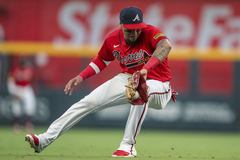 Atlanta Braves shortstop Orlando Arcia fields a grounder by Pittsburgh Pirates' Liover Peguero, who was out at first during the second inning of a baseball game Friday, Sept. 8, 2023, in Atlanta. (AP Photo/Hakim Wright Sr.)