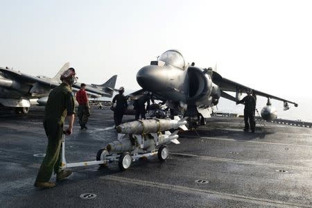 Marines prepare to load ordnance onto an AV-8B Harrier II on the flight deck of the amphibious assault ship USS Boxer in preparation for missions in support of Operation Inherent Resolve (U.S. military's operational name for the intervention against the Islamic State of Iraq and the Levant, ISIL), in the Arabian Gulf, June 16, 2016. Mass Communication Specialist 1st Class Brian Caracci/U.S. Navy/Handout via Reuters