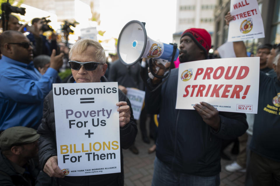 Drivers take part in a rally demanding more job security and livable incomes, at Uber and Lyft New York City Headquaters on May 8, 2019. - Rideshare drivers in major US cities were set to stage a series of strikes and protests Wednesday, casting a shadow over the keenly anticipated Wall Street debut of sector leader Uber. The app drivers for Uber, Lyft, Via and other platforms are seeking improved job security, including an end to arbitrary "deactivations," and a better revenue split between drivers and platforms. (Photo by Johannes EISELE / AFP)        (Photo credit should read JOHANNES EISELE/AFP via Getty Images)