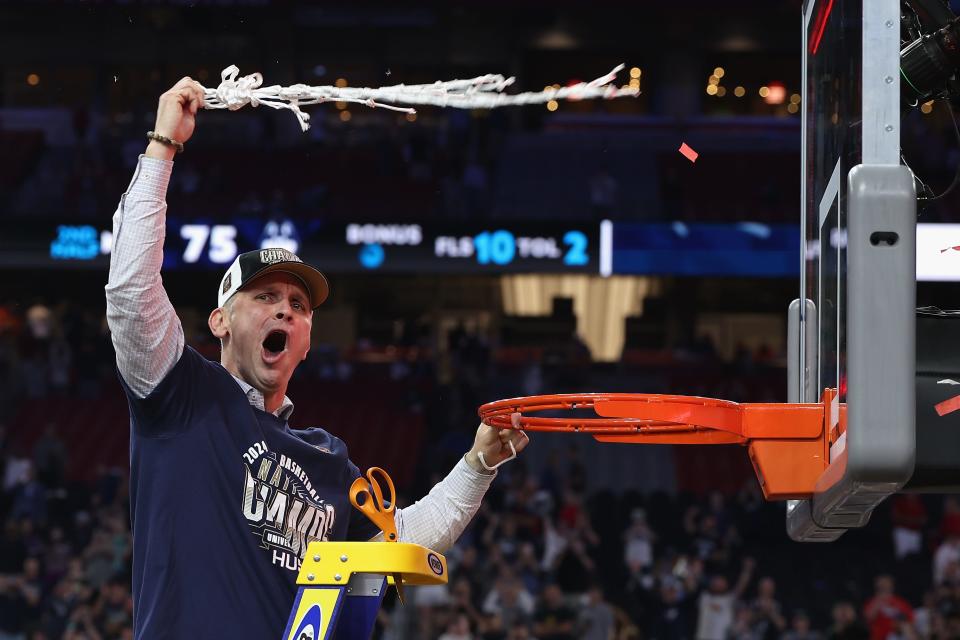 Coach Dan Hurley of the Connecticut Huskies cuts down the net after defeating the Purdue Boilermakers 75-60 to win the National Championship game of the NCAA Men's Basketball Tournament at State Farm Stadium on April 8, 2024 in Glendale, Arizona .