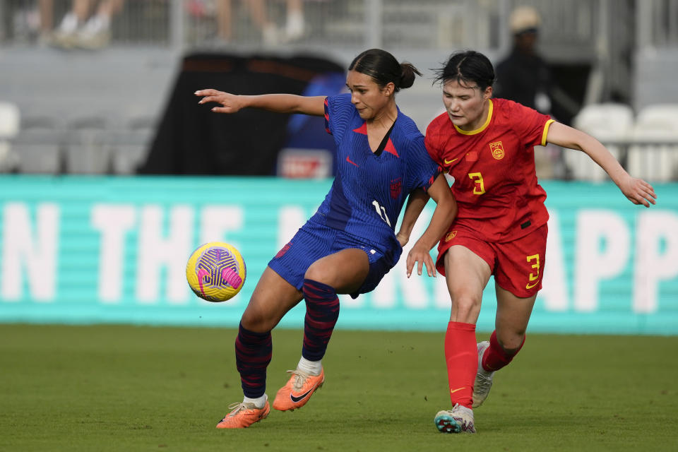 United States forward Sophia Smith (11) shields the ball from China defender Dou Jiaxing (3) during the first half of a women's International friendly soccer match, in Fort Lauderdale, Fla., Saturday, Dec. 2, 2023. (AP Photo/Rebecca Blackwell)