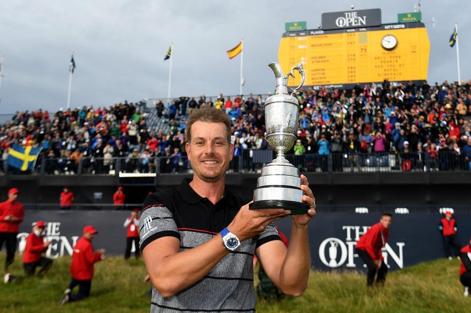Henrik Stenson poses with the Claret Jug on the 18th green following his victory during the final round of the British Open. (Getty Images)
