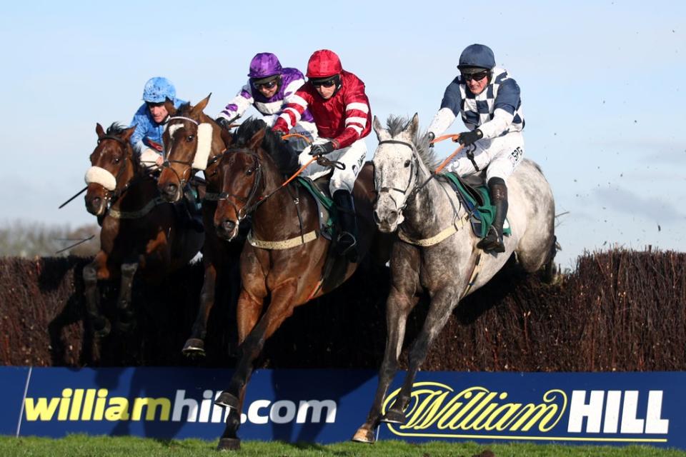 Runners and riders in the Handicap Chase at Aintree Racecourse, Merseyside. (PA)