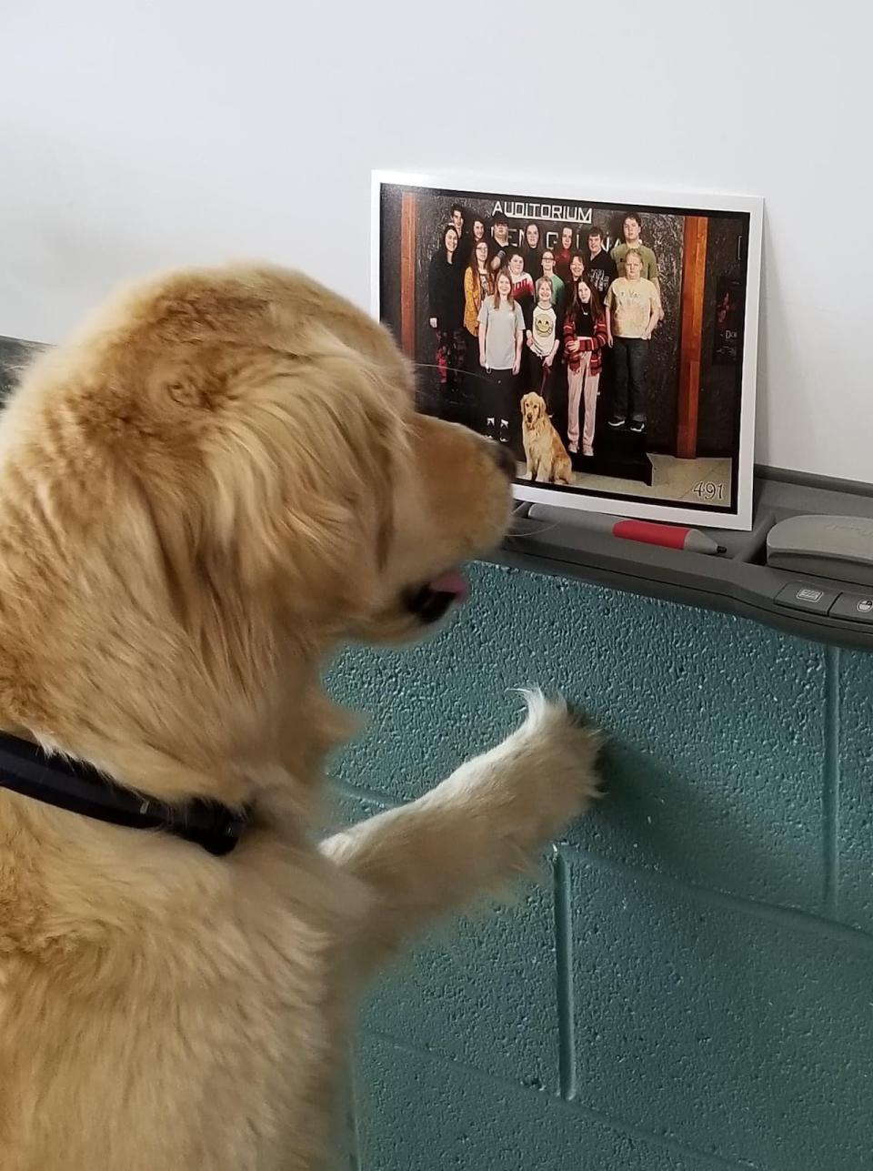 Cooper recognized himself in a photo of the class that sits on the white board.  