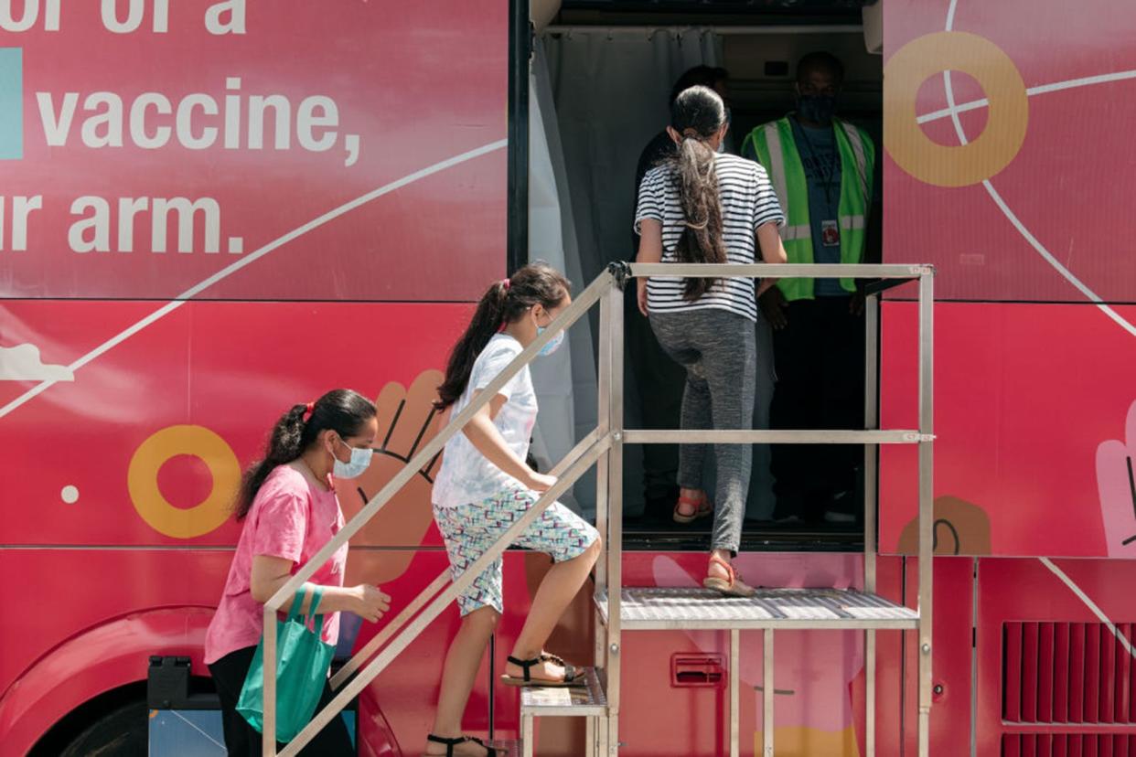 A family enters a pop-up COVID-19 vaccine site on June 5, 2021, in the Jackson Heights neighborhood in the Queens borough in New York City.