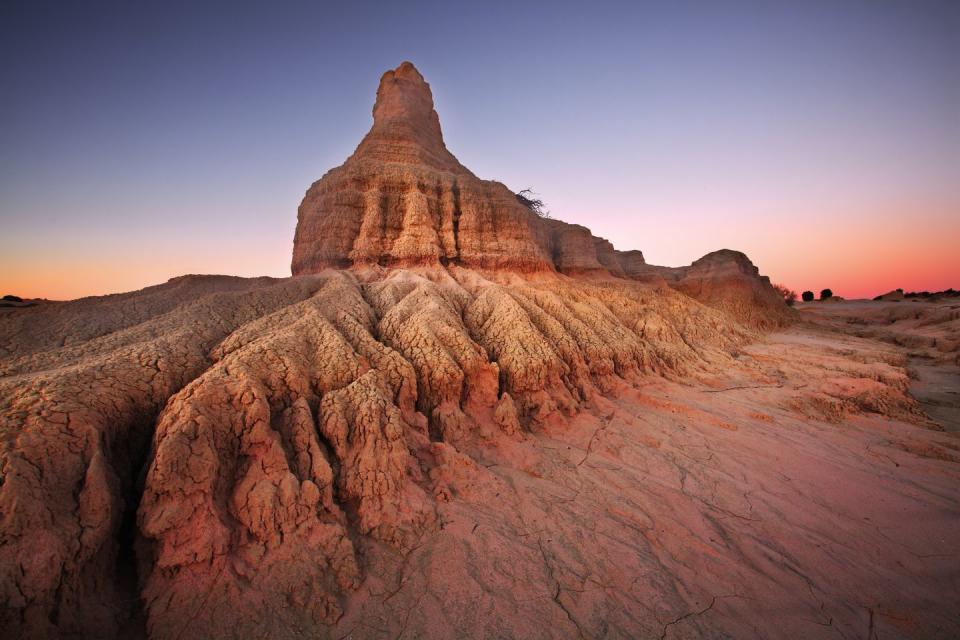 <p>The towering Lunette Rock Formation (also known as the 'Walls of China') at Mungo National Park during sunset.</p>