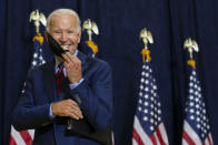 Democratic presidential candidate former Vice President Joe Biden smiles as he puts on his face mask after speaking to media in Wilmington, Del., on Sept. 4, 2020. (AP Photo/Carolyn Kaster)