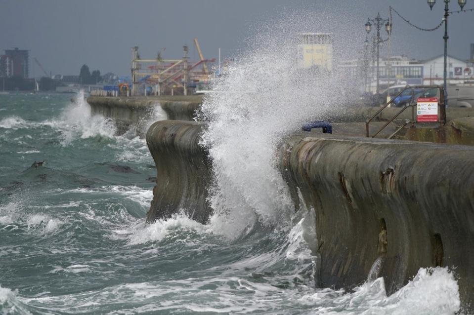 Waves crash against the sea walls in Southsea, Hampshire (PA) (PA Wire)