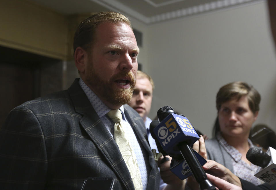 Attorney Curtis Briggs, representing Max Harris, speaks to reporters after a court hearing in Oakland, Calif., Friday, Aug. 17, 2018. Lawyers for Harris and Derick Almena, the two men charged in the Northern California warehouse fire that killed 36 people in Dec. 2016, said Friday they are now preparing for a trial where they will try to shift blame for the blaze from their clients to others, including the building's owner and government officials. (AP Photo/Lorin Eleni Gill)