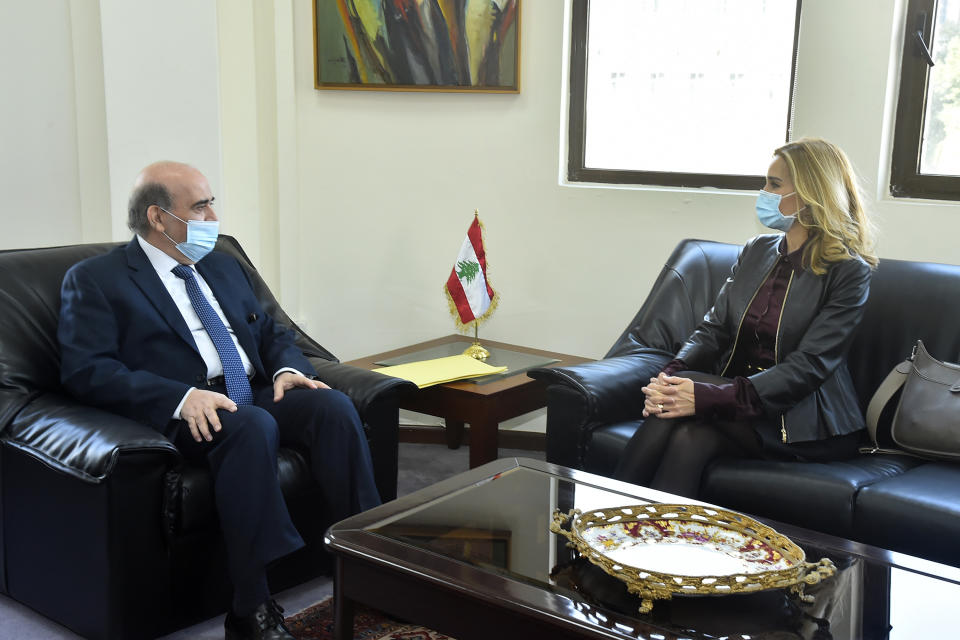 In this photo released by Lebanon's official government photographer Dalati Nohra, Lebanese Foreign Minister Charbel Wehbi, left, meets with Switzerland's ambassador to Lebanon Monika Schmutz Kirgöz, right, in Beirut, Lebanon, Monday, Jan. 25, 2021. Wehbi held talks Monday with Kirgöz days after Switzerland started a probe into possible money laundering and embezzlement at the country's central bank. (Dalati Nohra via AP)