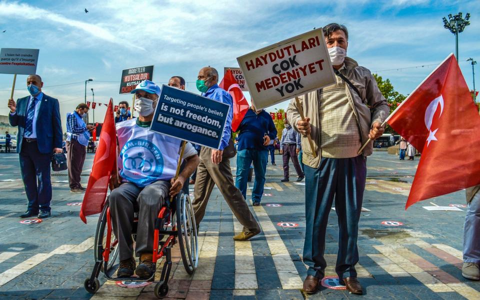 People protest against the French president in Ankara  - Altan Gocher/Barcroft Media via Getty Images