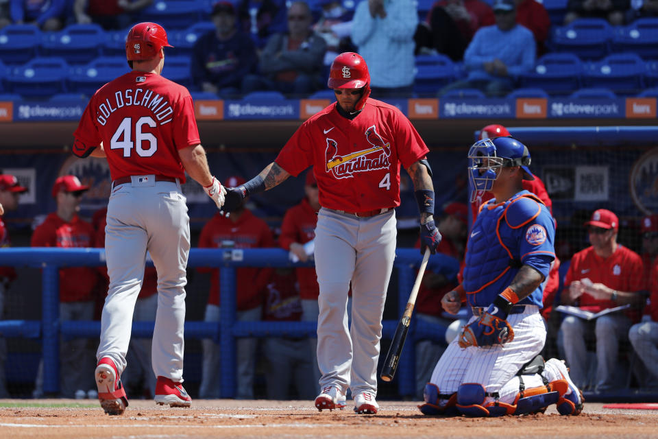 St. Louis Cardinals' Paul Goldschmidt (46) is congratulated by teammate Yadier Molina (4) after hitting a solo home run as New York Mets catcher Wilson Ramos, right, kneels at the plate during the first inning of a spring training baseball game Friday, Feb. 28, 2020, in Port St. Lucie, Fla. (AP Photo/Jeff Roberson)