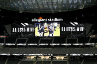 A screen shows Las Vegas Raiders players kneeling after defeating the New Orleans Saints in an NFL football game, Monday, Sept. 21, 2020, in Las Vegas. (AP Photo/David Becker)