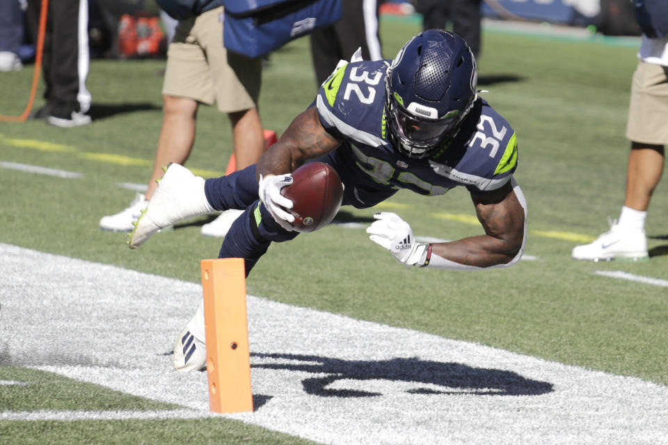 Seattle Seahawks running back Chris Carson (32) dives near the end zone during the first half of an NFL football game against the Dallas Cowboys, Sunday, Sept. 27, 2020, in Seattle. The Seahawks won 38-31. (AP Photo/John Froschauer)