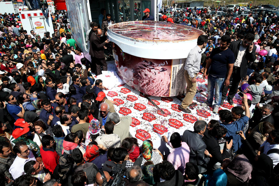 5-tons of ice-cream made by Iranian Choopan dairy is displayed during a ceremony at the Tochal mountainous area of northern Tehran, Iran, Monday, April 1, 2013. Choopan dairy unveiled 5-tons of chocolate ice-cream, the largest in the world, according to the factory officials. (AP Photo/Ebrahim Noroozi)