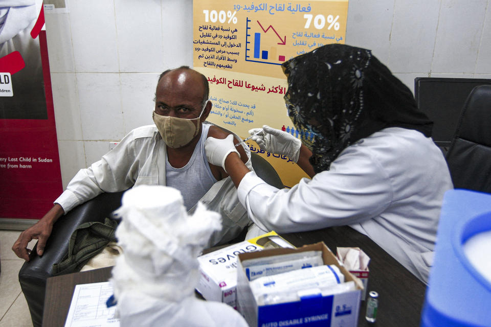 A medical worker receives a dose of the Oxford-AstraZeneca COVID-19 coronavirus vaccine at the Jabra Hospital for Emergency and Injuries in Sudan's capital Khartoum on March 9, 2021. - Sudan is the first in the Middle East and North Africa to receive vaccines through COVAX, a UN-led initiative that provides jabs to poor countries, according to children's agency UNICEF. The first batch to arrive was comprised of 828,000 doses of the AstraZeneca vaccine, which are planned to cover 414,000 frontline health care workers across the country, according to health officials. (Photo by Ebrahim HAMID / AFP) (Photo by EBRAHIM HAMID/AFP via Getty Images)