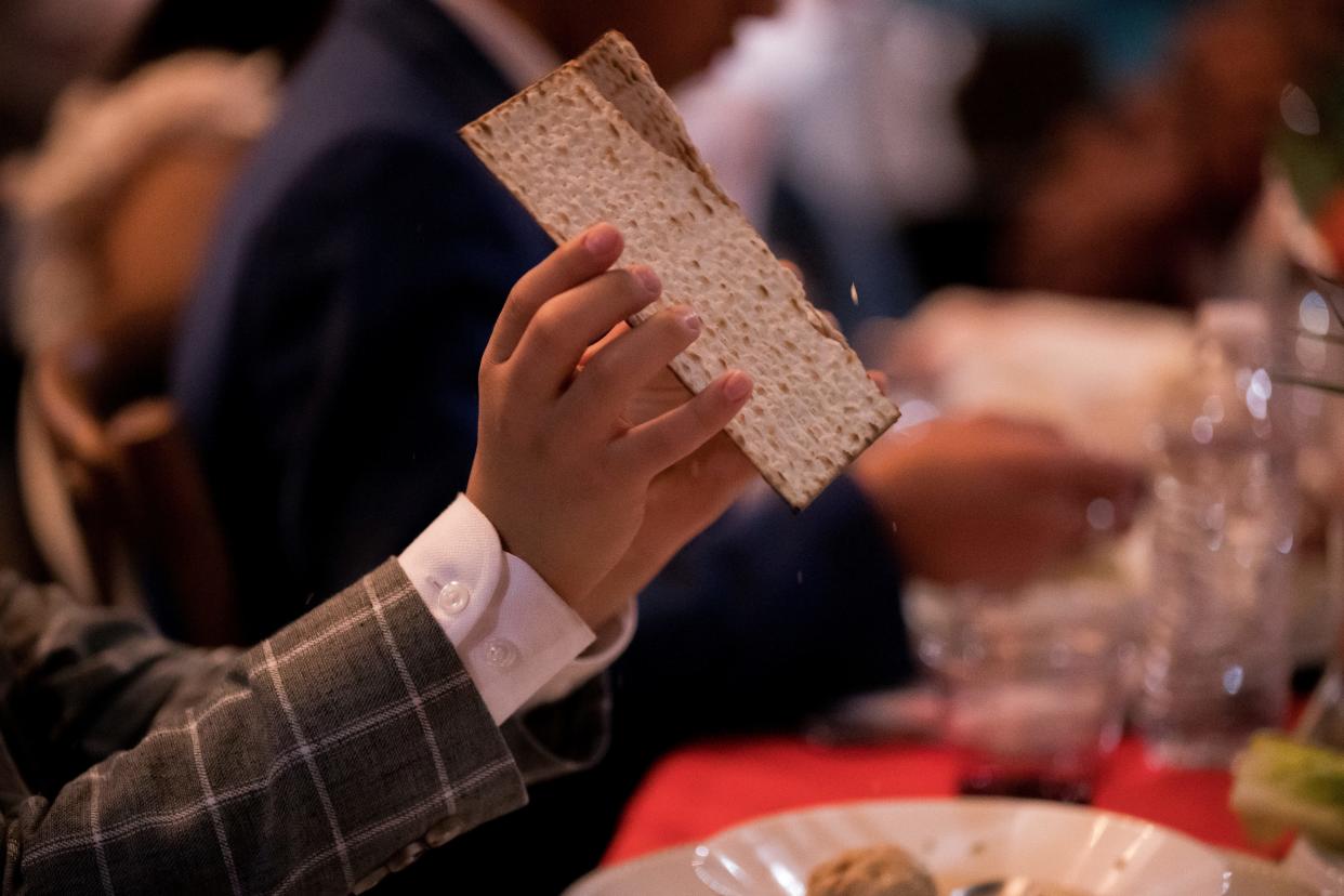 The Jewish community in El Paso pass over unleavened bread as they gather celebrating Passover Seder on Saturday, April 8, 2023, in Sunland Park, New Mexico.