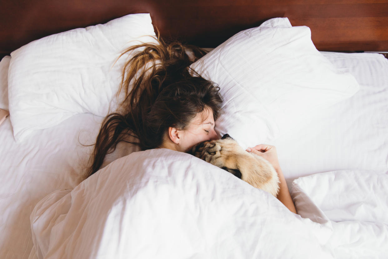 A quarter of women would rather sleep in a bed with their pet over their partner. (Getty Images)