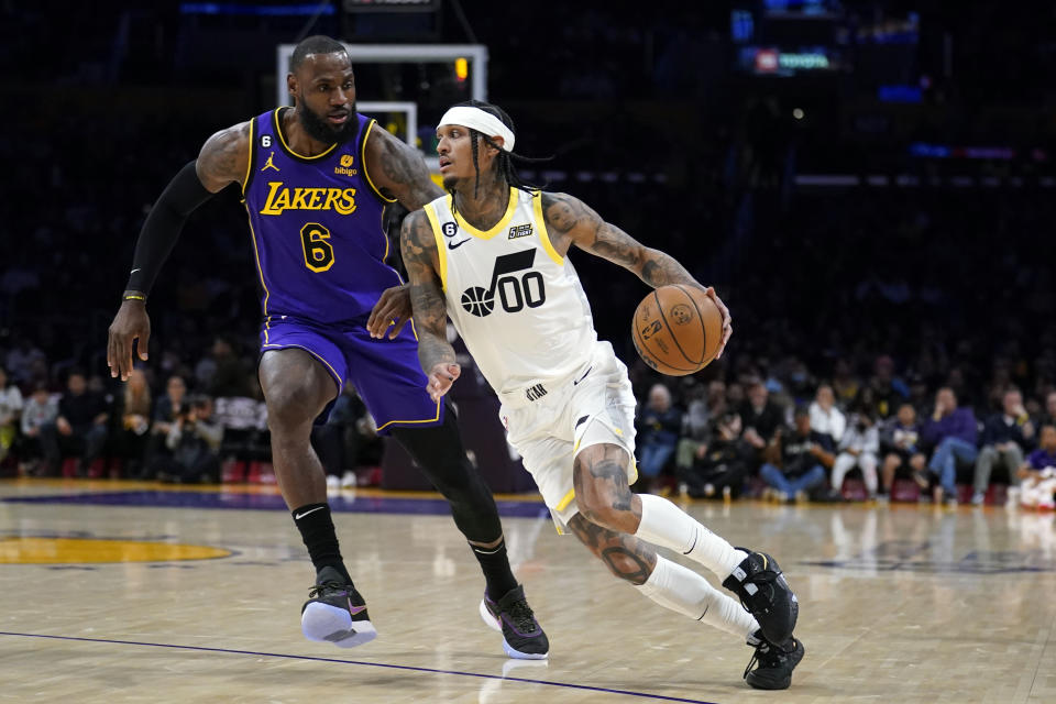 Utah Jazz guard Jordan Clarkson (00) dribbles past Los Angeles Lakers forward LeBron James (6) during the first half of an NBA basketball game Friday, Nov. 4, 2022, in Los Angeles. (AP Photo/Marcio Jose Sanchez)