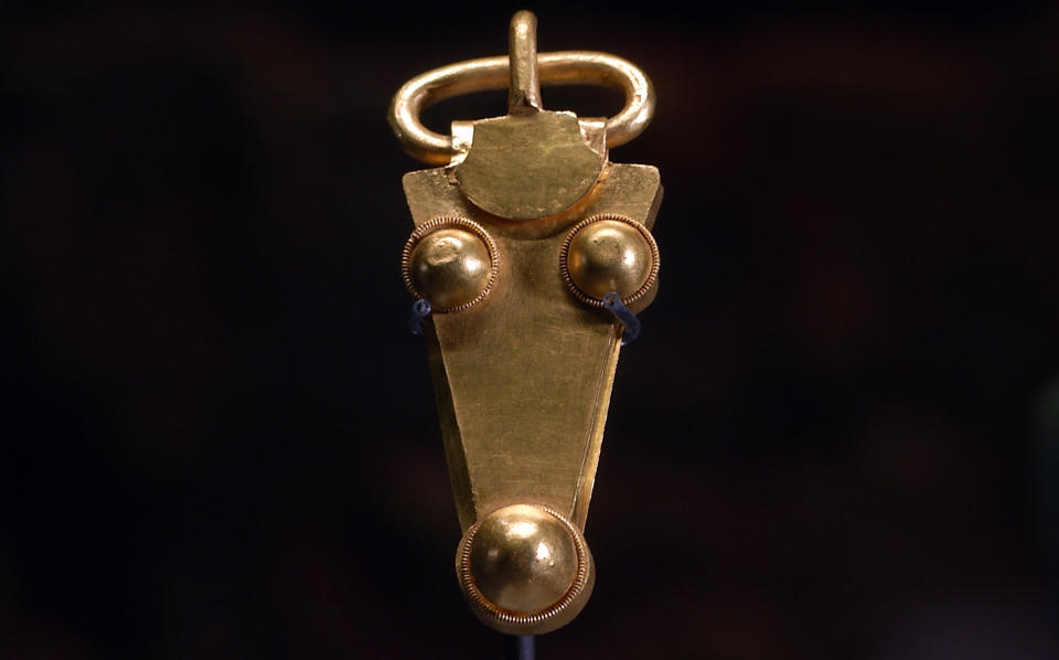 A golden belt buckle uncovered at an Anglo-Saxon burial site in the village of Prittlewell in 2003 on display at Southend Central Museum in Southend, England, Thursday, May 8, 2019. Archaeologists say an underground chamber discovered accidentally by road workers may be the site of the earliest Christian royal burial in Britain. The chamber uncovered between a road and a railway line in the village of Prittlewell in 2003 turned out to be a 1,400-year-old burial site. (AP Photo/James Brooks)