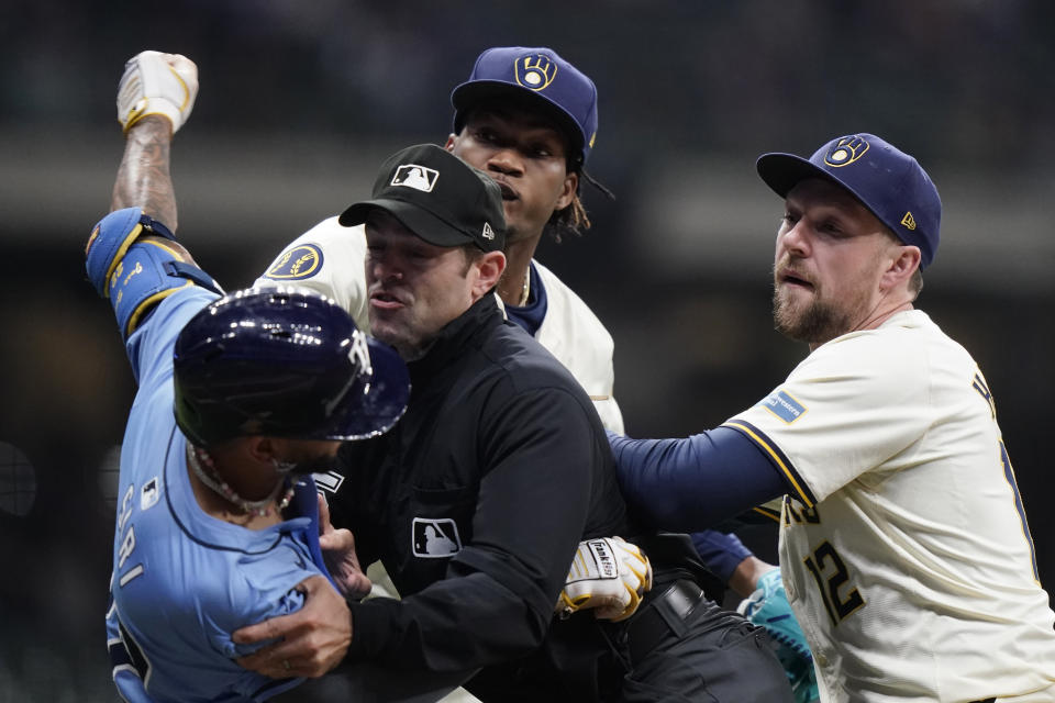 Tampa Bay Rays' Jose Siri, left, fights with Milwaukee Brewers' Abner Uribe, middle, during the eighth inning of a baseball game Tuesday, April 30, 2024, in Milwaukee. (AP Photo/Aaron Gash)