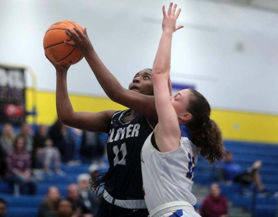 Clover’s Nysheria Wright heads to the basket ahead of Fort Mill’s Lindsay Paukovitz.