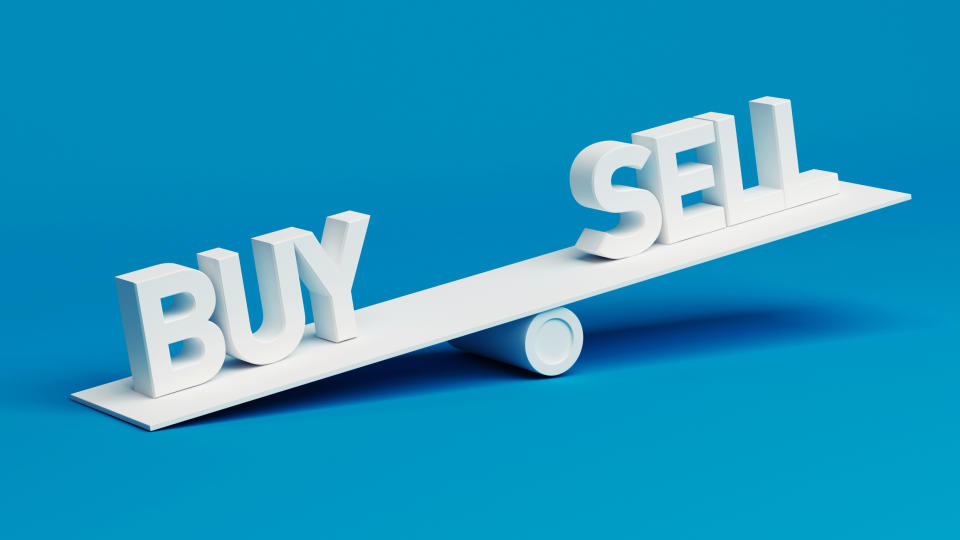 A scale with the word buy on one side and the word sell on the other