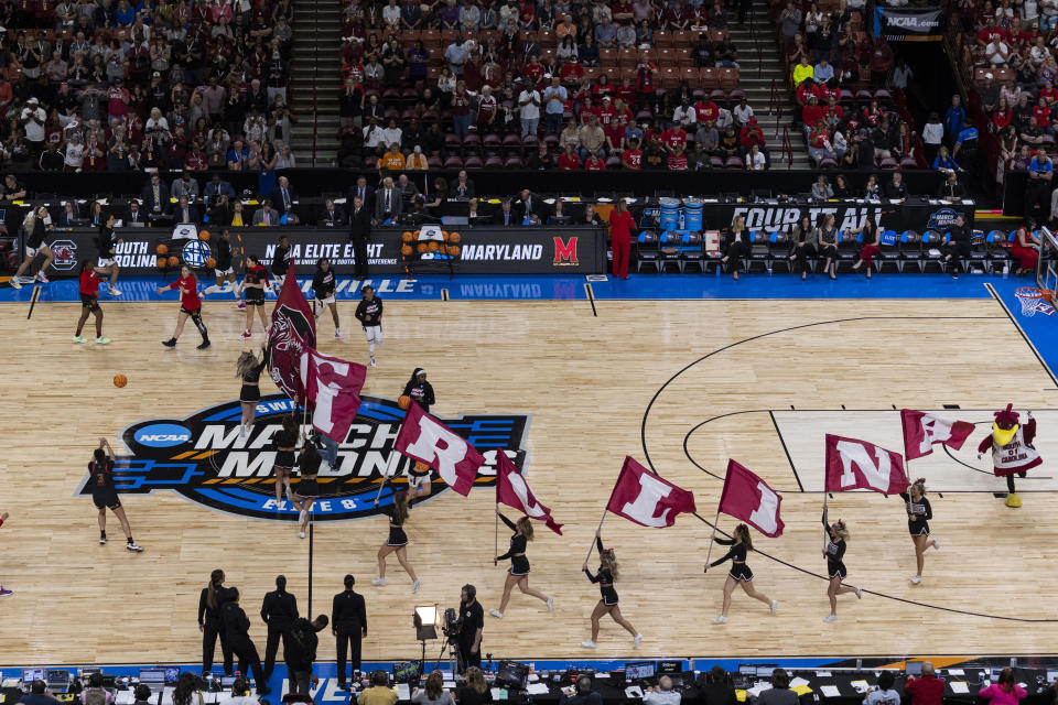 South Carolina cheerleaders and players enter the court before an Elite 8 college basketball game against Maryland in the NCAA Tournament in Greenville, S.C., Monday, March 27, 2023. (AP Photo/Mic Smith)