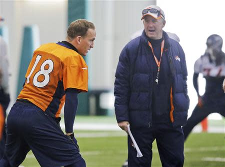 Denver Broncos quarterback Peyton Manning talks with head coach John Fox during their practice session for the Super Bowl at the New York Jets Training Center in Florham Park, New Jersey January 30, 2014. REUTERS/Ray Stubblebine