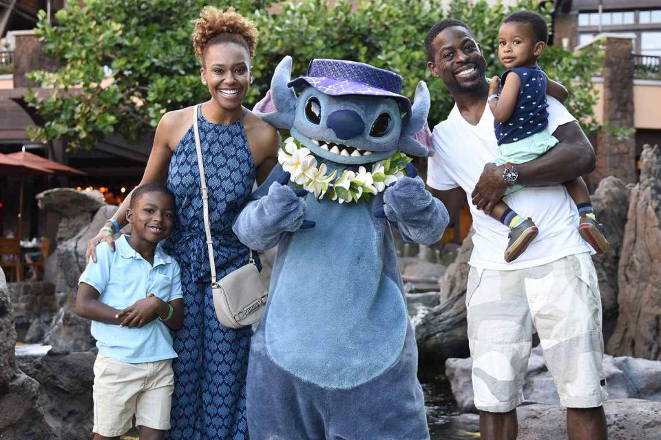 KO OLINA, HI - DECEMBER 27: In this handout photo provided by Disney Parks, Actor Sterling K. Brown, wife Ryan Bathe and children Andrew and Amare hang with Stitch at Aulani, a Disney Resort & Spa on December 27, 2017 in Ko Olina, Hawaii. (Photo by Hugh Gentry/Disney's Aulani Resort via Getty Images)