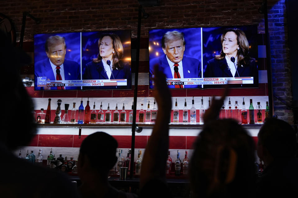 Viewers cheer as they watch a debate between Democratic presidential nominee Vice President Kamala Harris and Republican presidential nominee former President Donald Trump at the Angry Elephant Bar and Grill, Tuesday, Sept. 10, 2024, in San Antonio. (AP Photo/Eric Gay)