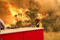 <p>Los Angeles County firefighters pause to fight the flames due to erratic winds in Placenta Caynon Road in Santa Clarita. (AP Photo/Matt Hartman)<br></p>