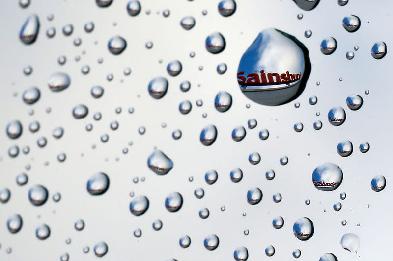 FILE PHOTO: A Sainsbury's sign is seen reflected in raindrops on a window in London January 6, 2015. REUTERS/Stefan Wermuth/File Photo