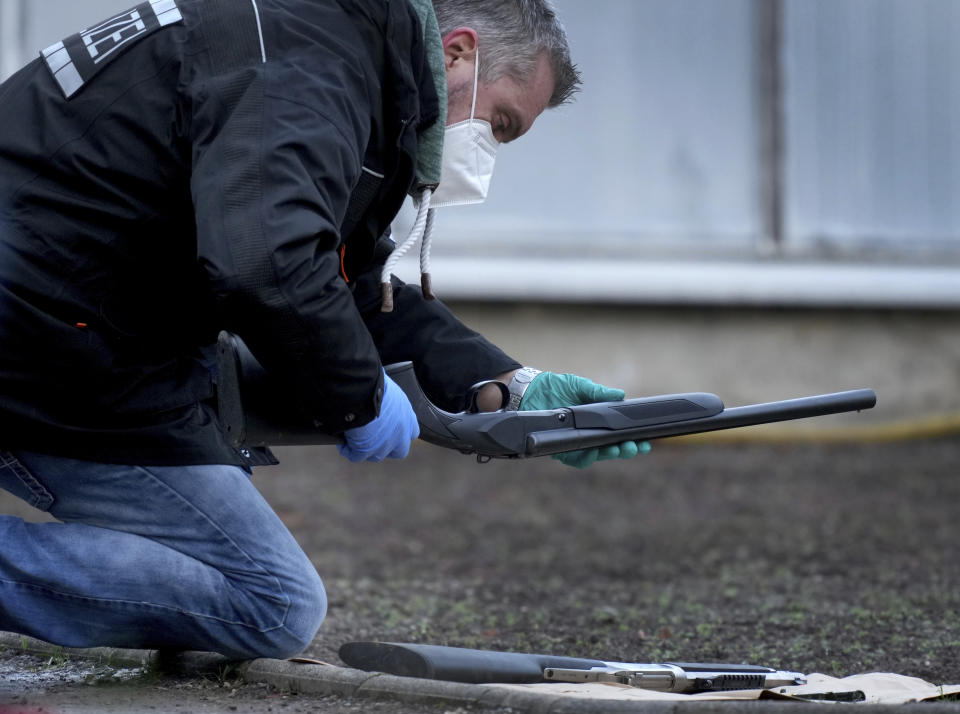 A Police officer secures traces on the grounds of the Heidelberg University Botanical Garden in Heidelberg, Germany, Monday, Jan. 24, 2022. German police say a lone gunman wounded several people at a lecture theatre in the southwest city of Heidelberg on Monday. Police said in a brief statement that the perpetrator was dead but didn't give details of how that happened.(AP Photo/Michael Probst)