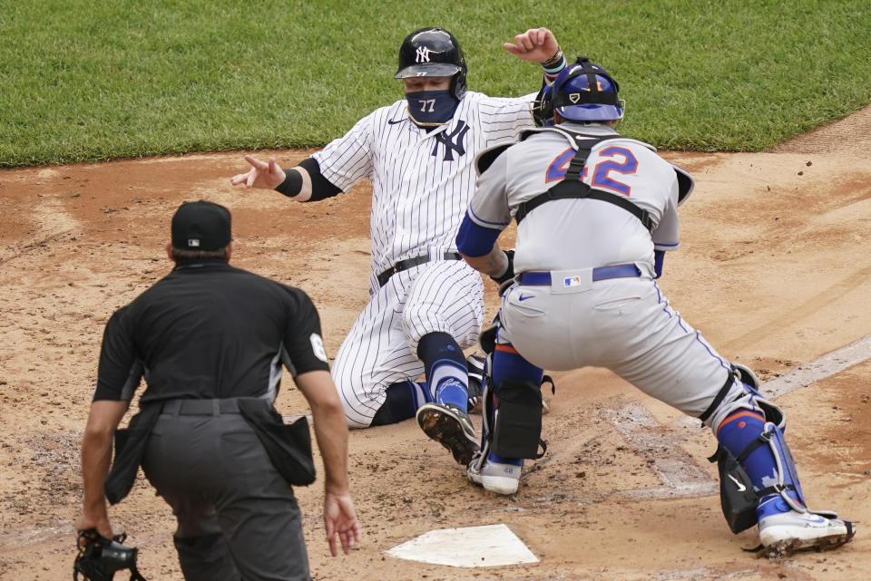 New York Yankees' Clint Frazier (77) is tagged out at home by New York Mets catcher Wilson Ramos, right, in the fourth inning of a baseball game, Saturday, Aug. 29, 2020, in New York. (AP Photo/John Minchillo)