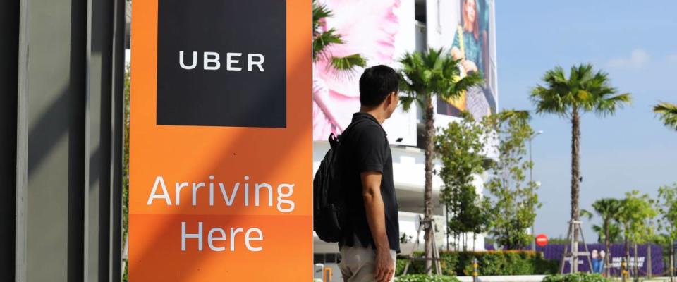 PENANG, MALAYSIA - OCTOBER 17, 2017: Passenger is waiting for Uber car at pick up location.