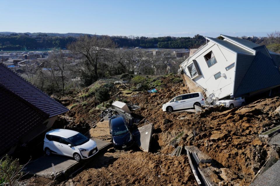 A view of a damaged home and vehicles following a strong earthquake in Kanazawa, Ishikawa Prefecture (EPA)